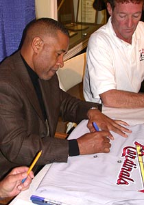 Ozzie Smith Signs A Cardinal Jersey